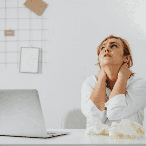 Woman taking a break from looking at her computer, stressed and frustrated.