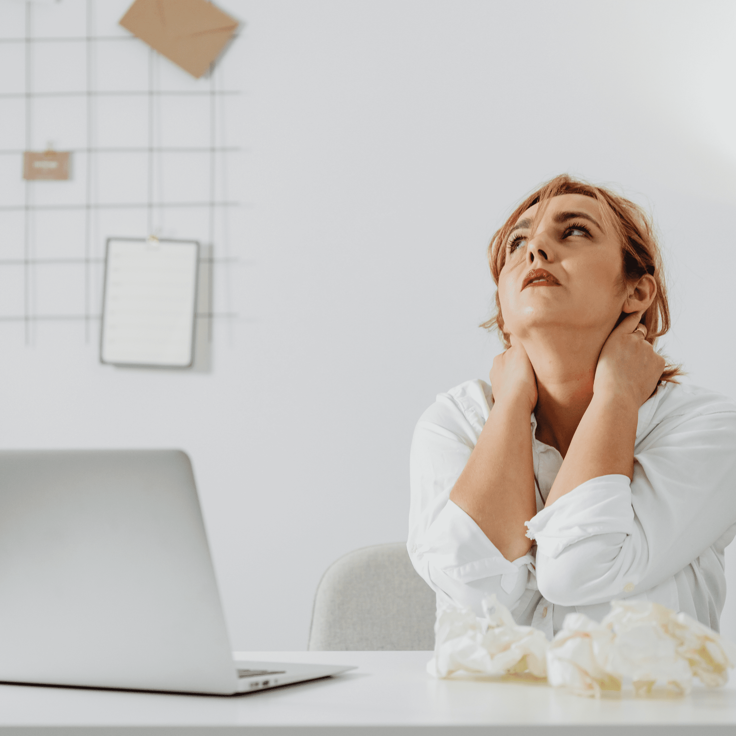 Woman taking a break from looking at her computer, stressed and frustrated.